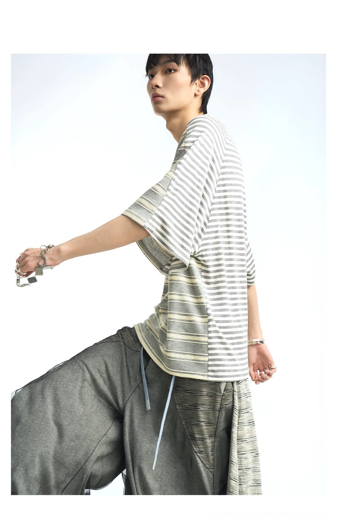 Gray and white oversized striped T-shirt profile view with dropped sleeves and relaxed fit