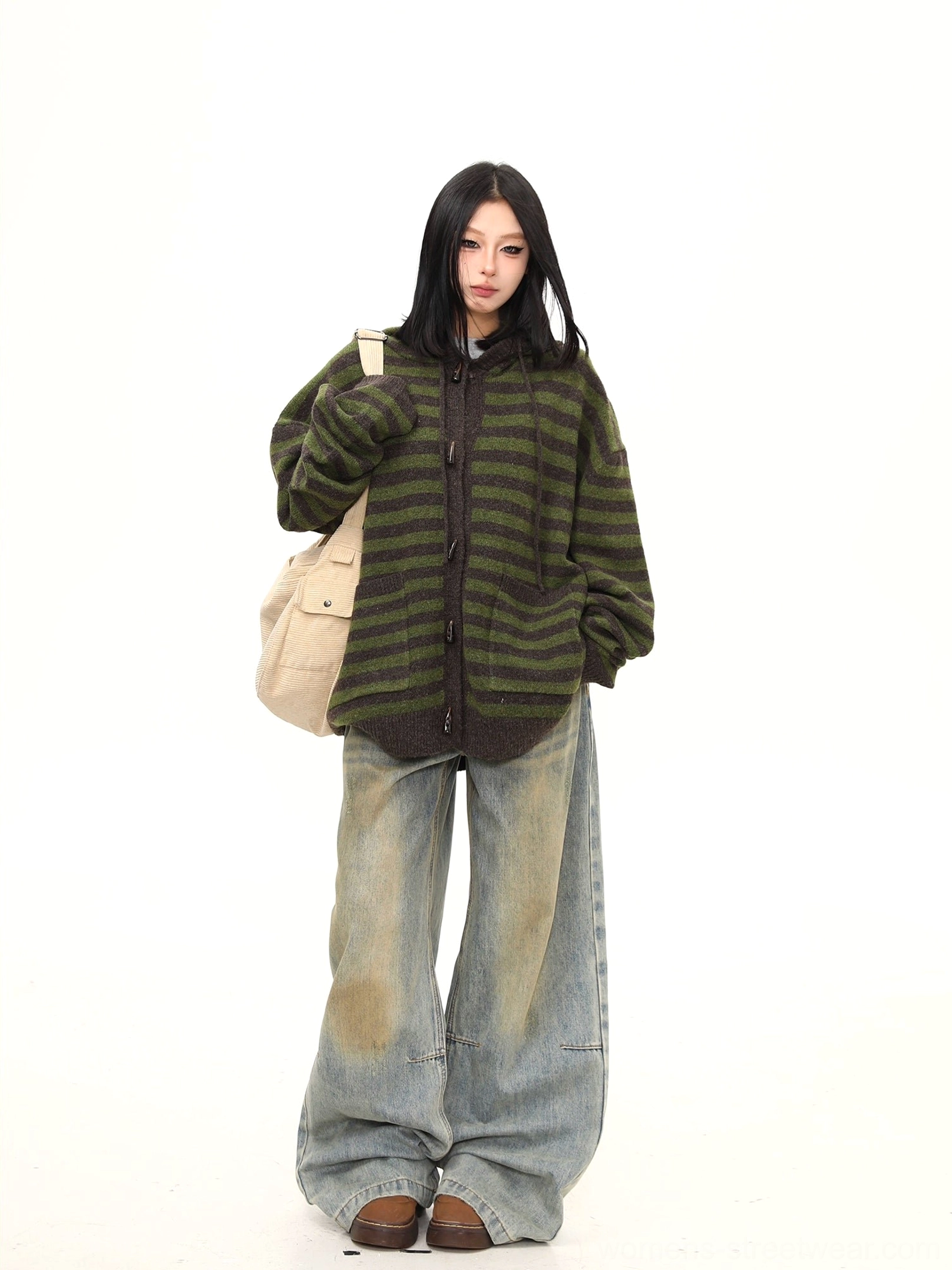 Full-body styling of a relaxed oversized striped knit hoodie cardigan with toggle closures worn with wide-leg jeans, loafers, and a canvas tote