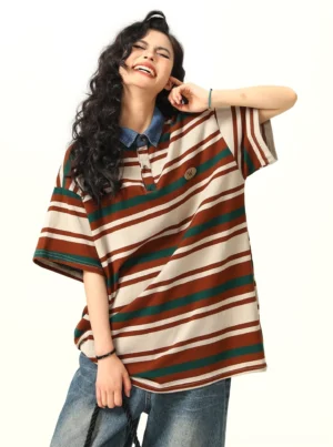 Women's oversized striped polo shirt with denim collar and embroidered chest badge three quarter front view