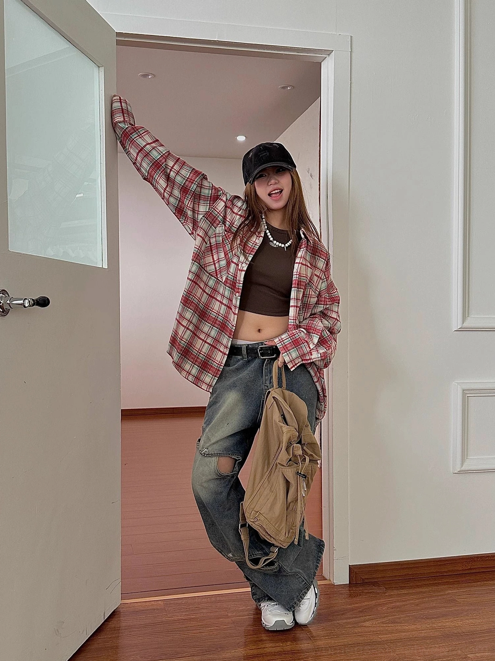 Oversized tartan check shirt with front buttons and chest pocket for modern casual fashion styling