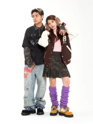 Male and female models wearing oversized two-tone work boots with chunky lug soles in matching streetwear outfits