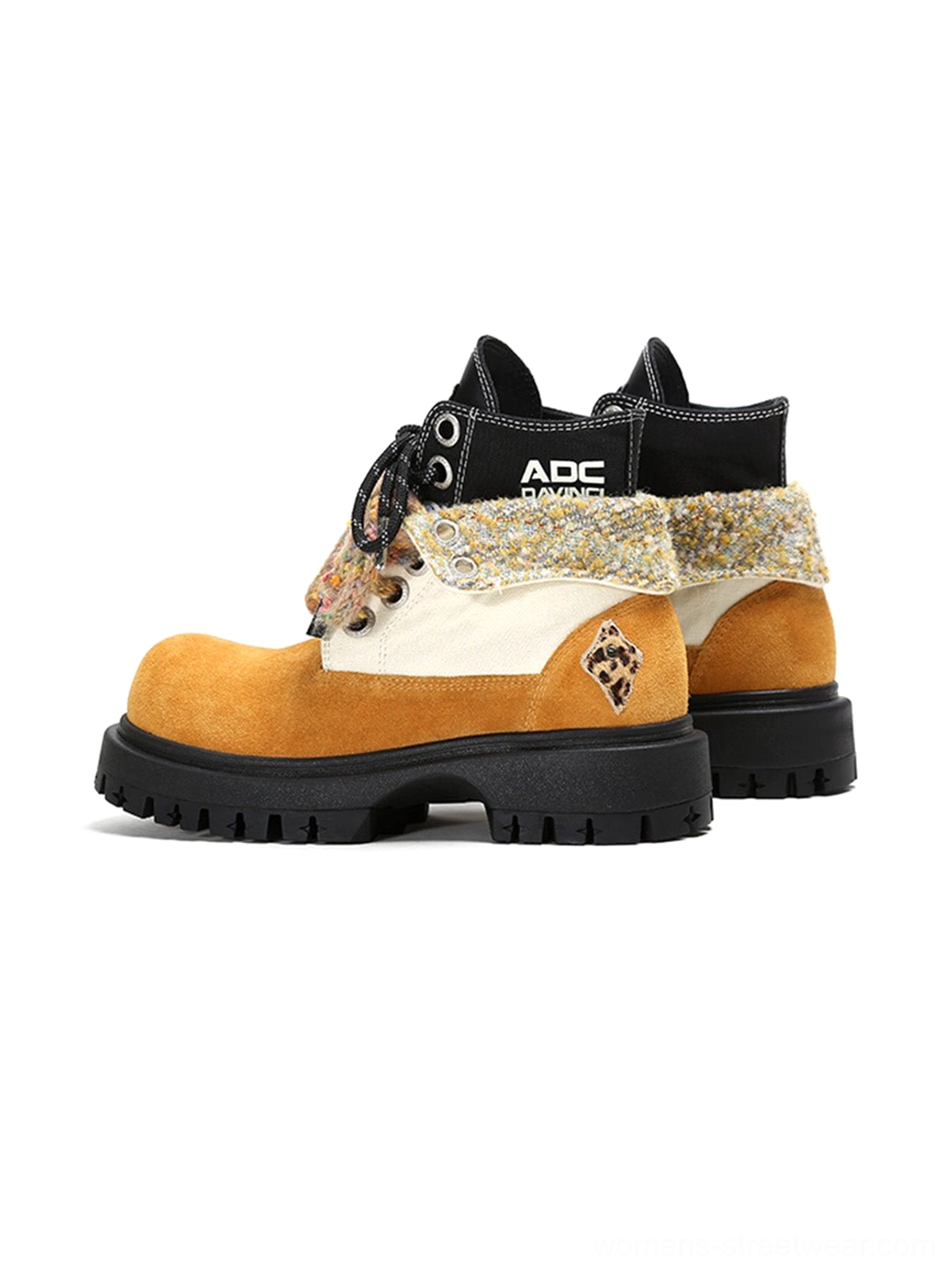 Rear side view of oversized two-tone work boots showing heel construction, side patch detail and chunky lug soles