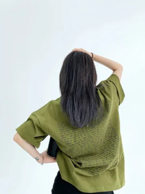 Army green oversized typography back print streetwear cotton T-shirt shown from the back on a female model