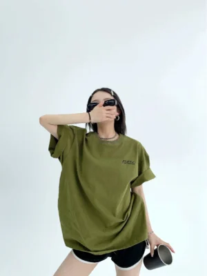 Army green oversized streetwear cotton T-shirt with rolled sleeves and small embroidered chest detail front view
