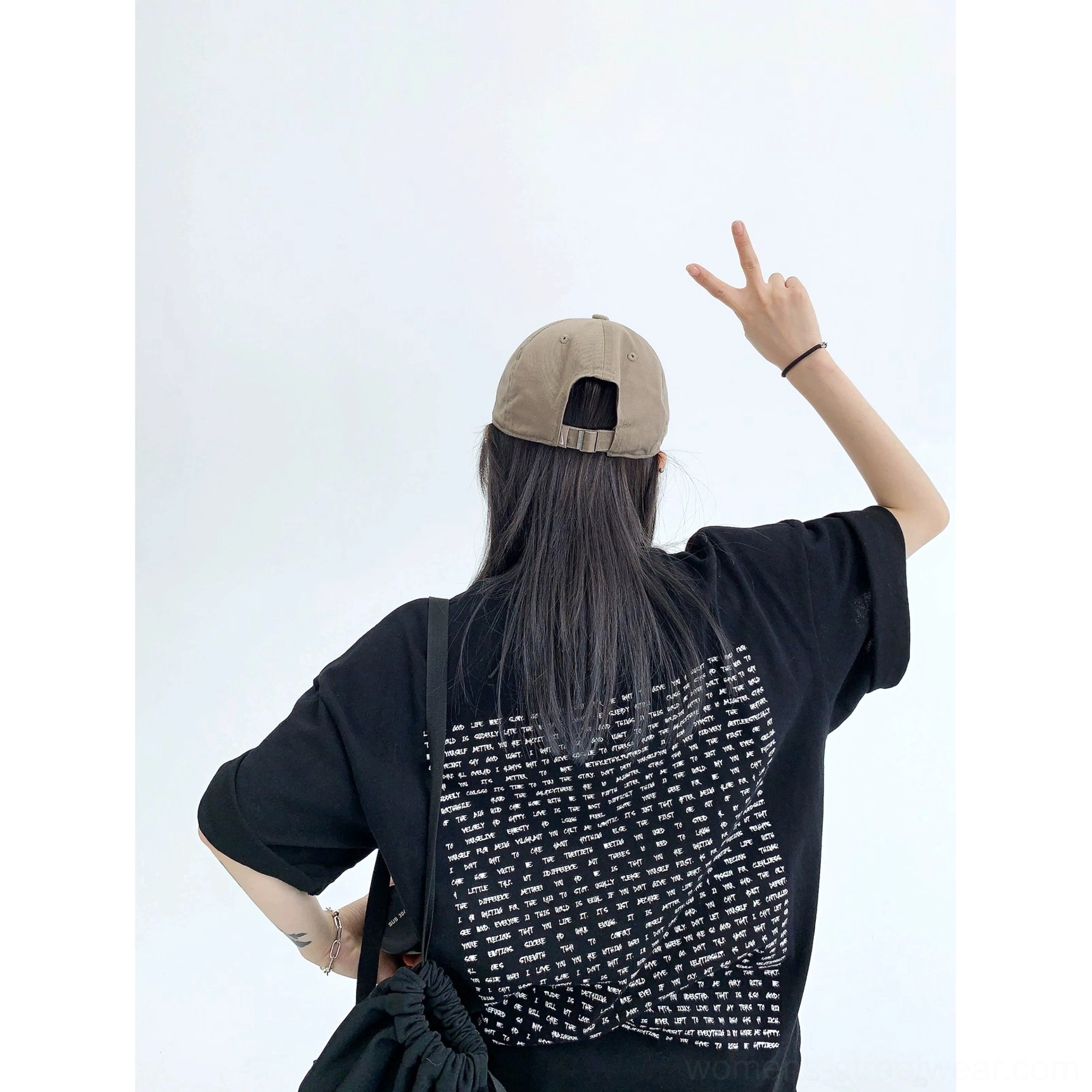 Black oversized typography back print streetwear cotton T-shirt shown from the back with relaxed boxy silhouette