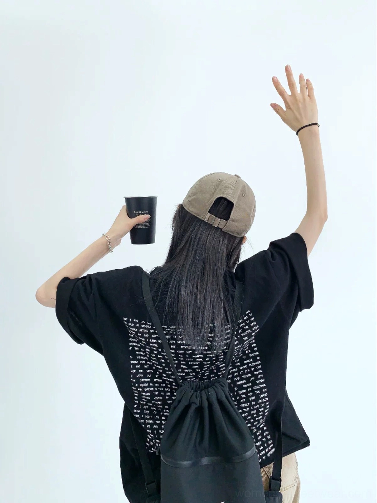 Black oversized streetwear T-shirt with dense typography graphic print across the full back