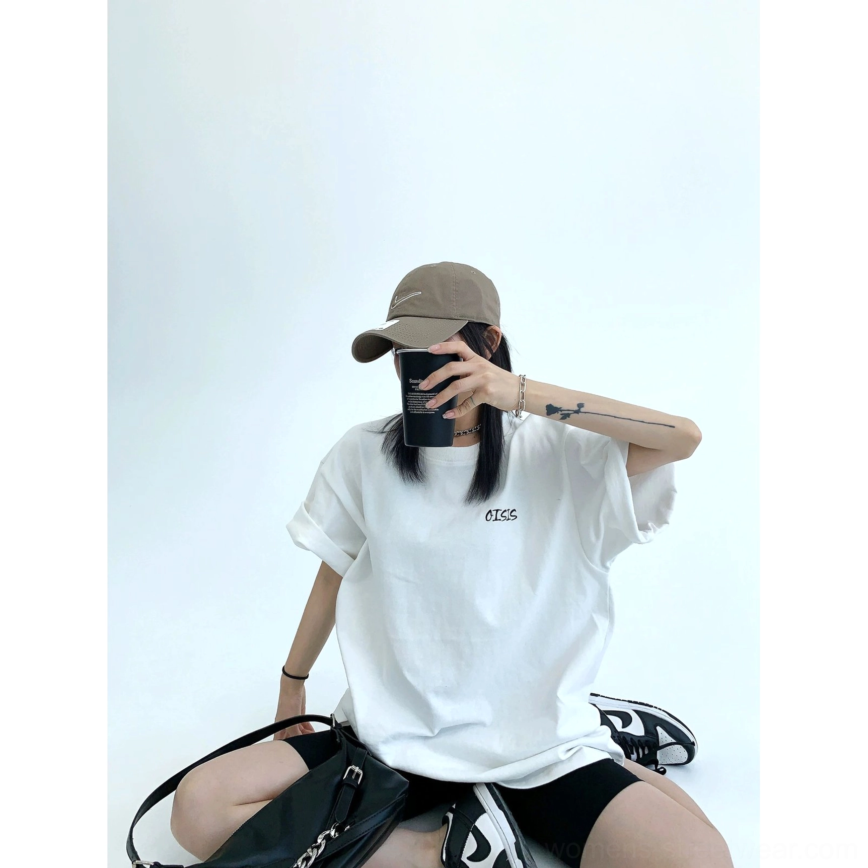 White oversized streetwear cotton T-shirt front view with minimal embroidered chest detail and loose fit