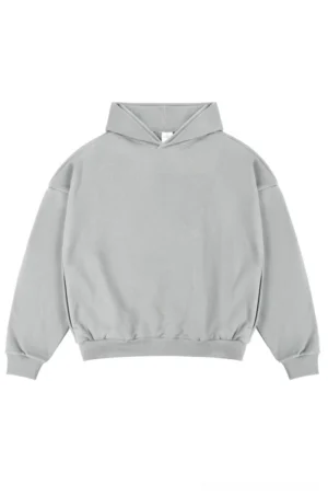 Light heather gray oversized unisex streetwear hoodie with dropped shoulders ribbed cuffs and classic hood on a white studio background