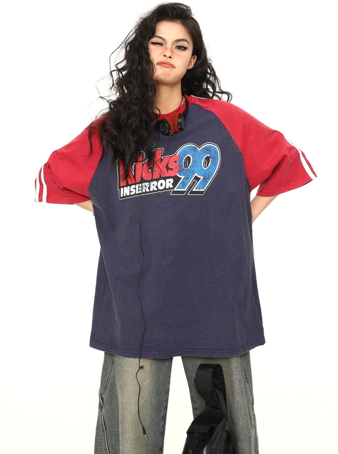Navy blue oversized varsity baseball raglan graphic T-shirt with contrast red sleeves and retro chest print shown in a front full-body studio view