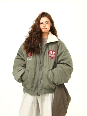 Army green oversized varsity patch bomber jacket with fleece collar shown in a full front streetwear outfit