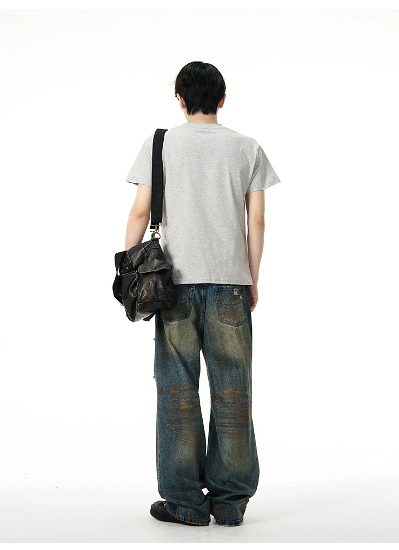 Rear view of oversized vintage blue baggy jeans showing classic back pockets, loose wide legs, and distressed denim styling