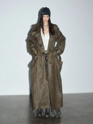 Full front view of an oversized vintage olive green trench coat with double-breasted buttons, matching waist belt, and full-length streetwear silhouette