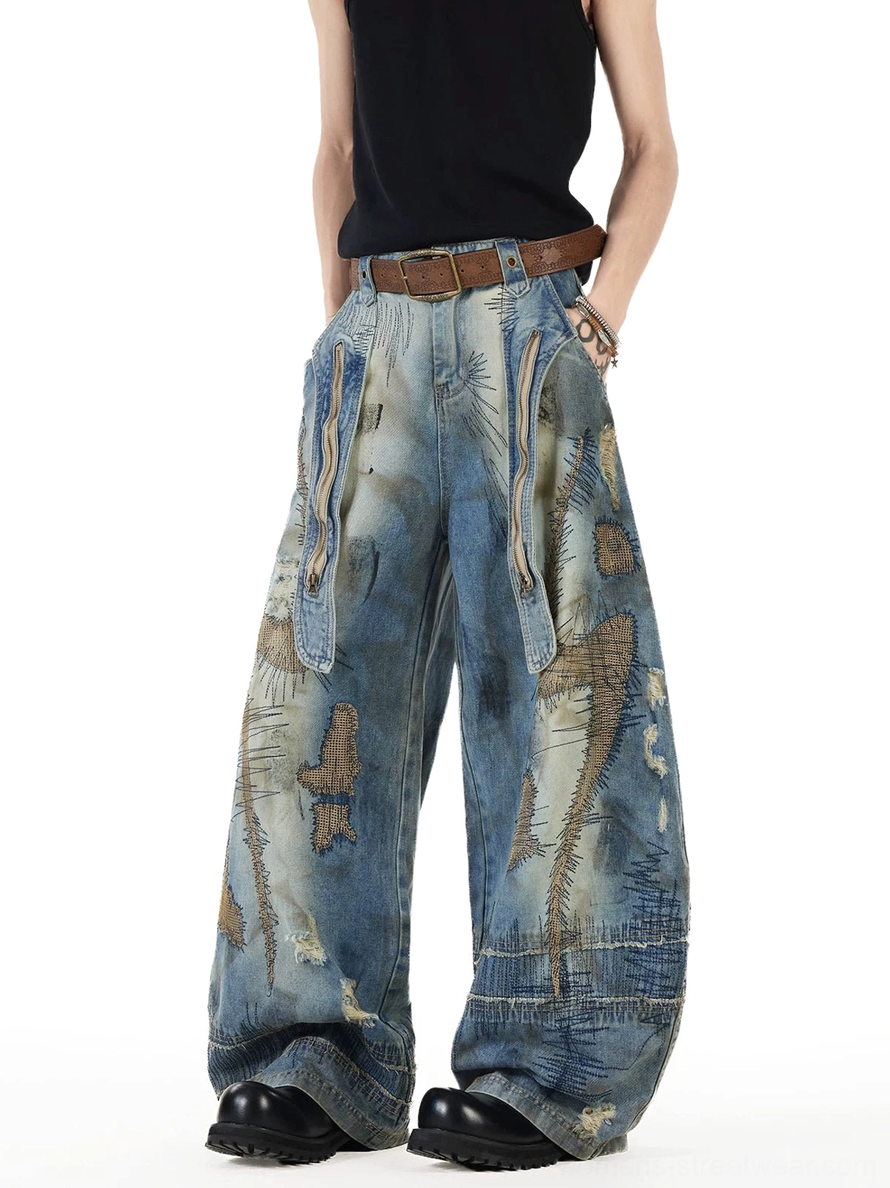 Right front view of oversized vintage patchwork jeans featuring asymmetrical hand-stitched details, dual utility pockets, faded blue denim, and super baggy balloon legs