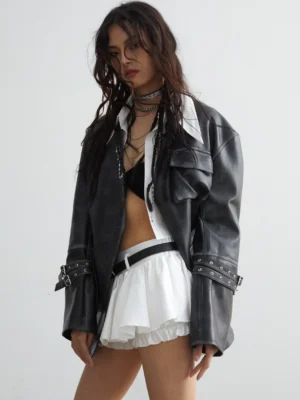 Oversized faded black-grey PU leather jacket worn open with utility pockets, adjustable buckle cuffs, and relaxed Korean streetwear styling