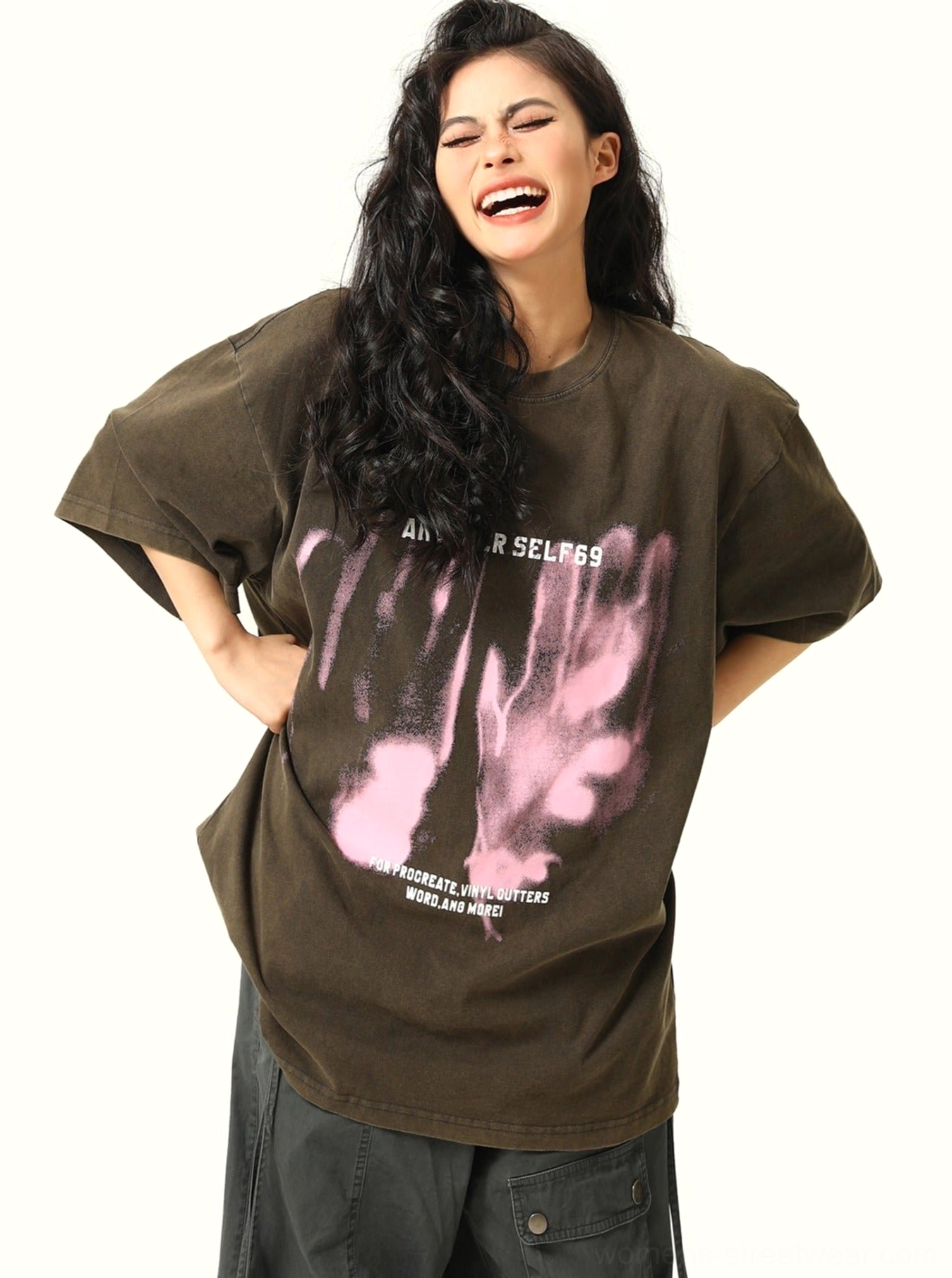 Close front view of black washed oversized handprint graphic T-shirt with pink slogan artwork
