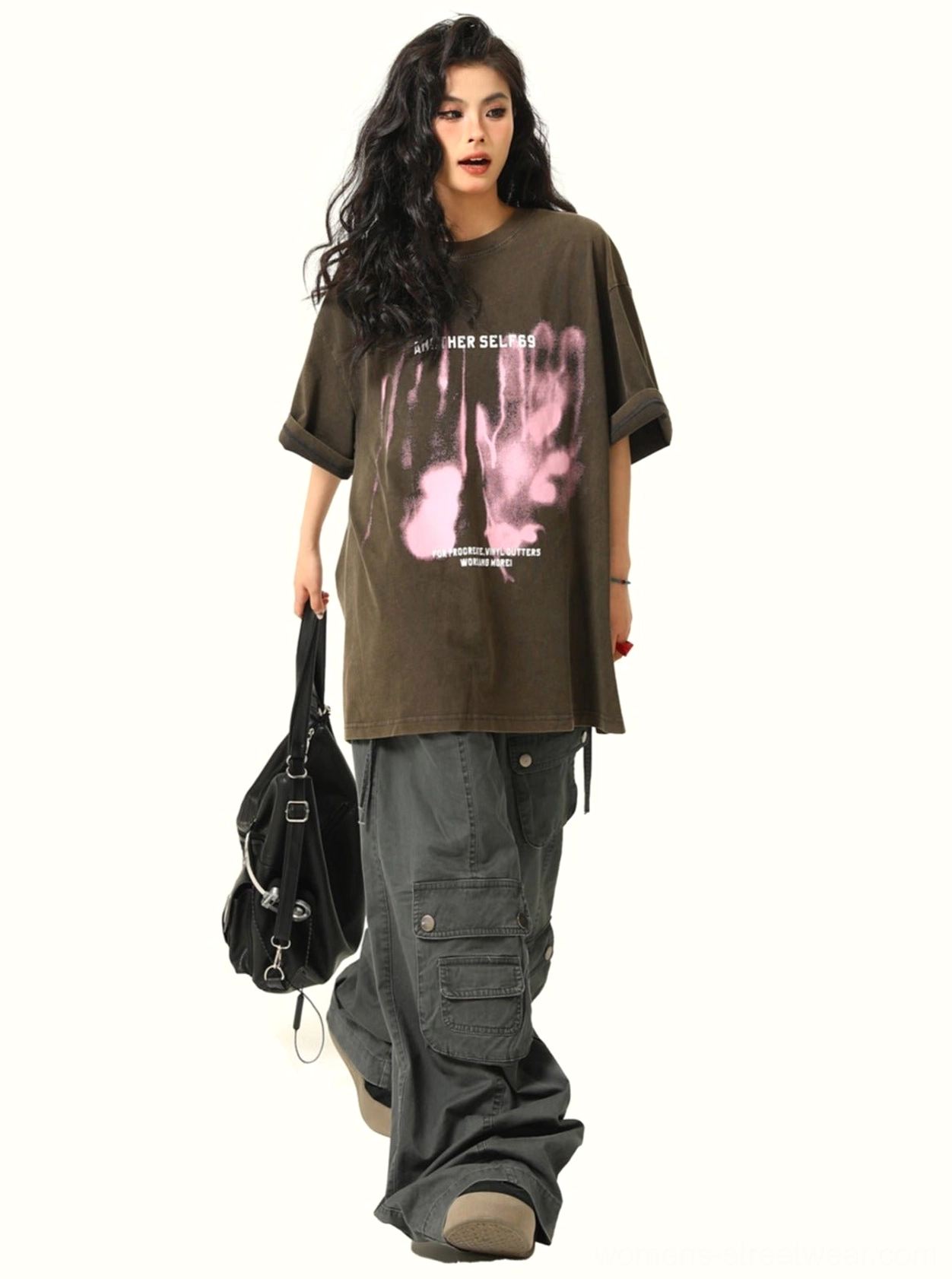 Side view of black oversized washed grunge graphic T-shirt showing long relaxed streetwear silhouette