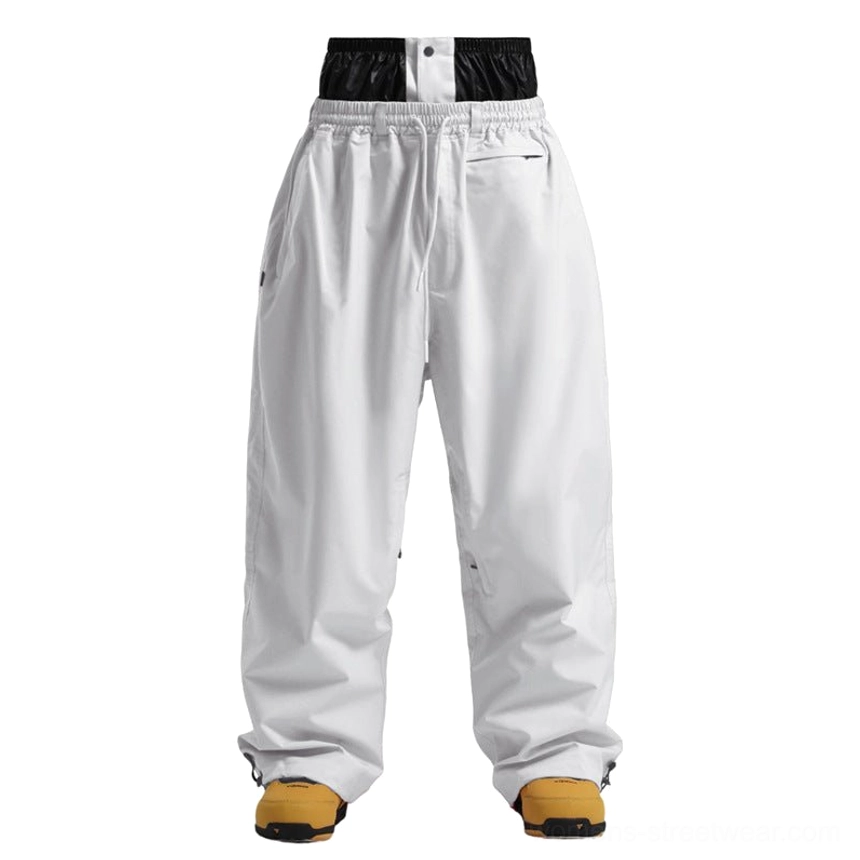 Wide leg streetwear snow pants with adjustable cuffs designed to stack over snowboard boots