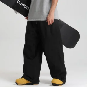 Black baggy waterproof snowboarding pants with adjustable cuffs and streetwear wide leg silhouette