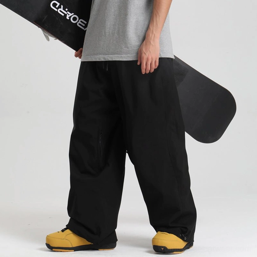 Black baggy waterproof snowboarding pants with adjustable cuffs and streetwear wide leg silhouette