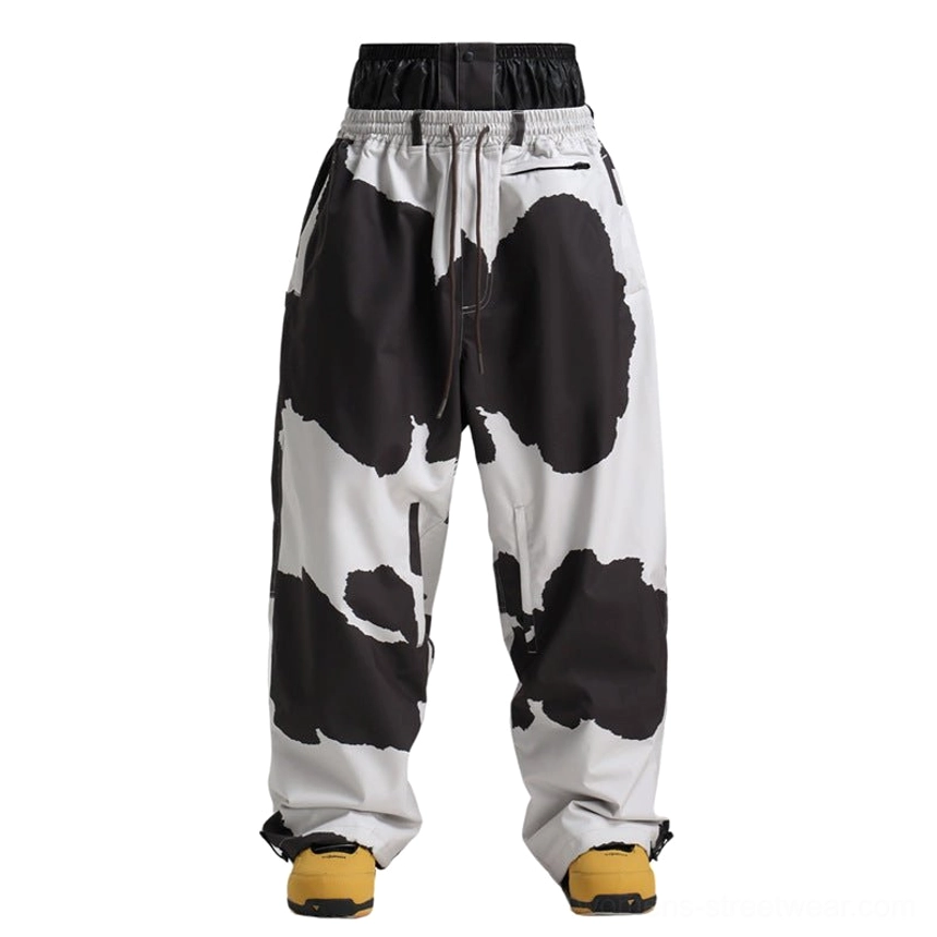 Cow print oversized waterproof snow pants in black and white for bold streetwear snowboarding style
