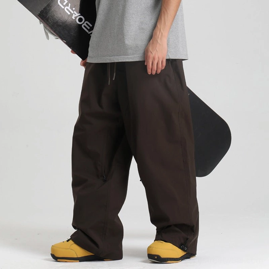 Dark brown oversized snow pants with drawstring waist and loose streetwear snowboard fit