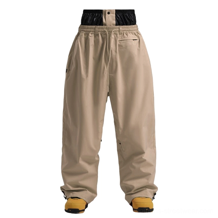 Khaki relaxed fit snowboarding pants with waterproof shell, elastic waist, and adjustable cuffs