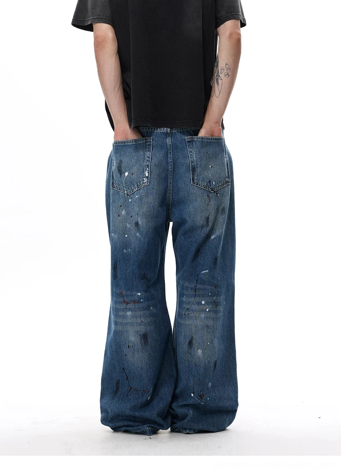 Paint splatter distressed wide-leg Y2K jeans in vintage blue denim with oversized streetwear silhouette