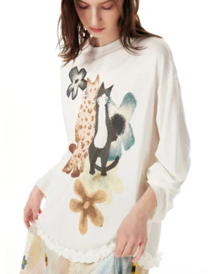 Close-up front view of white painterly cat print ruffle hem lyocell oversized tunic with floral artwork