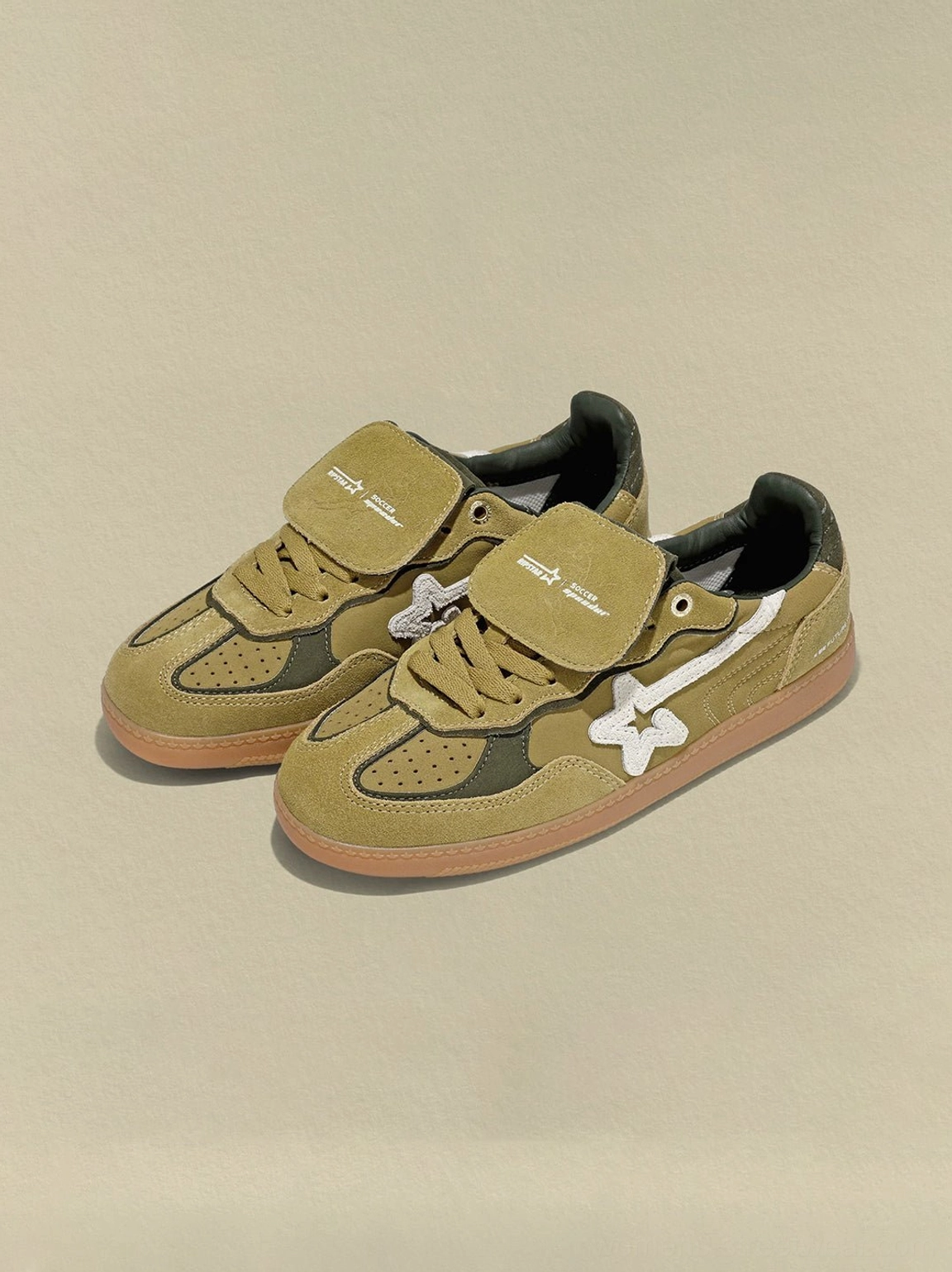 Pair of avocado olive retro suede sneakers with white star accents and hook-and-loop tongue straps