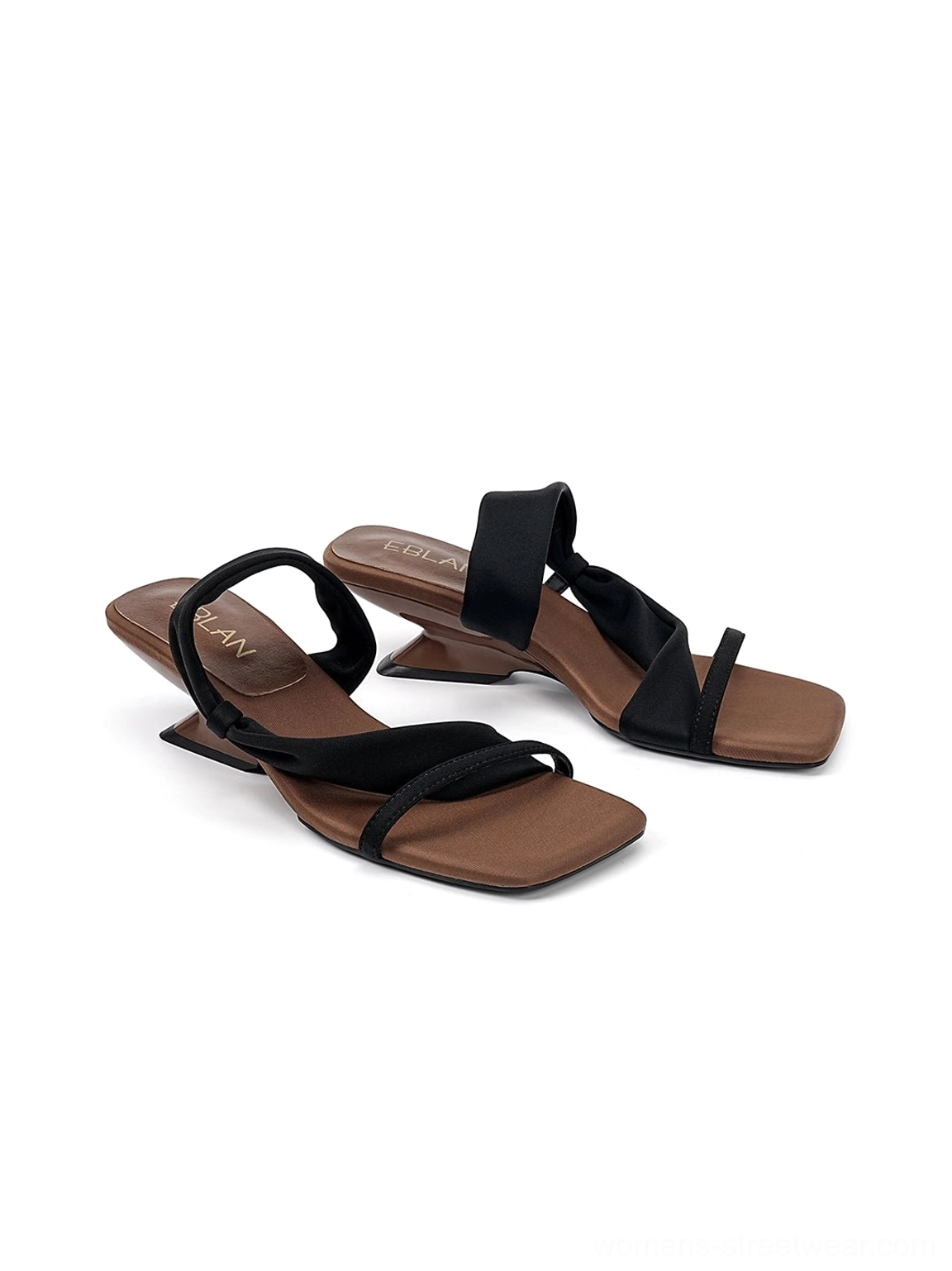 Pair of black asymmetric strap sandals with square open toes and brown sculptural wedge soles front view
