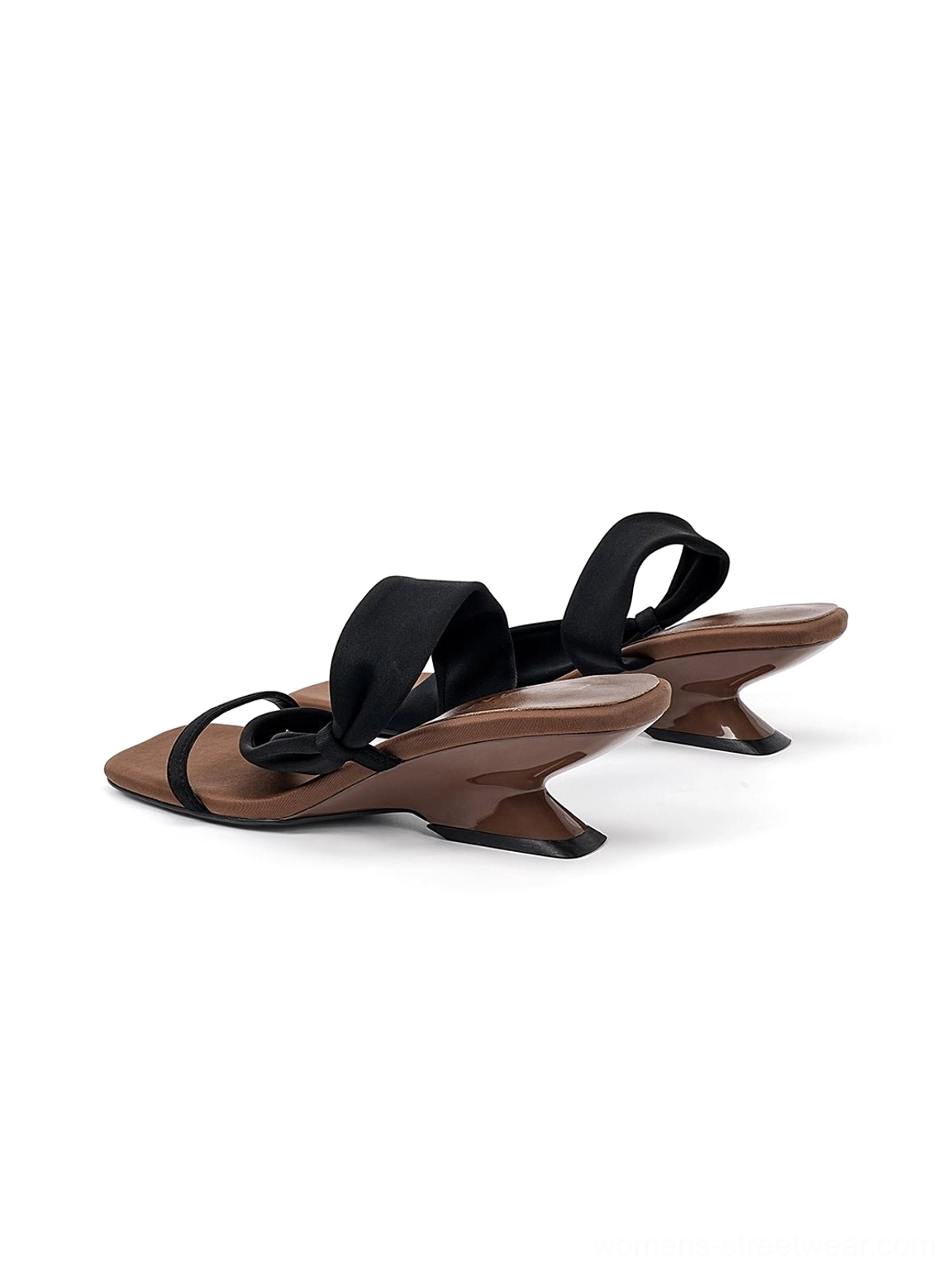 Pair of black asymmetric strap slide sandals with minimalist square toes and matching brown sculptural wedge heels