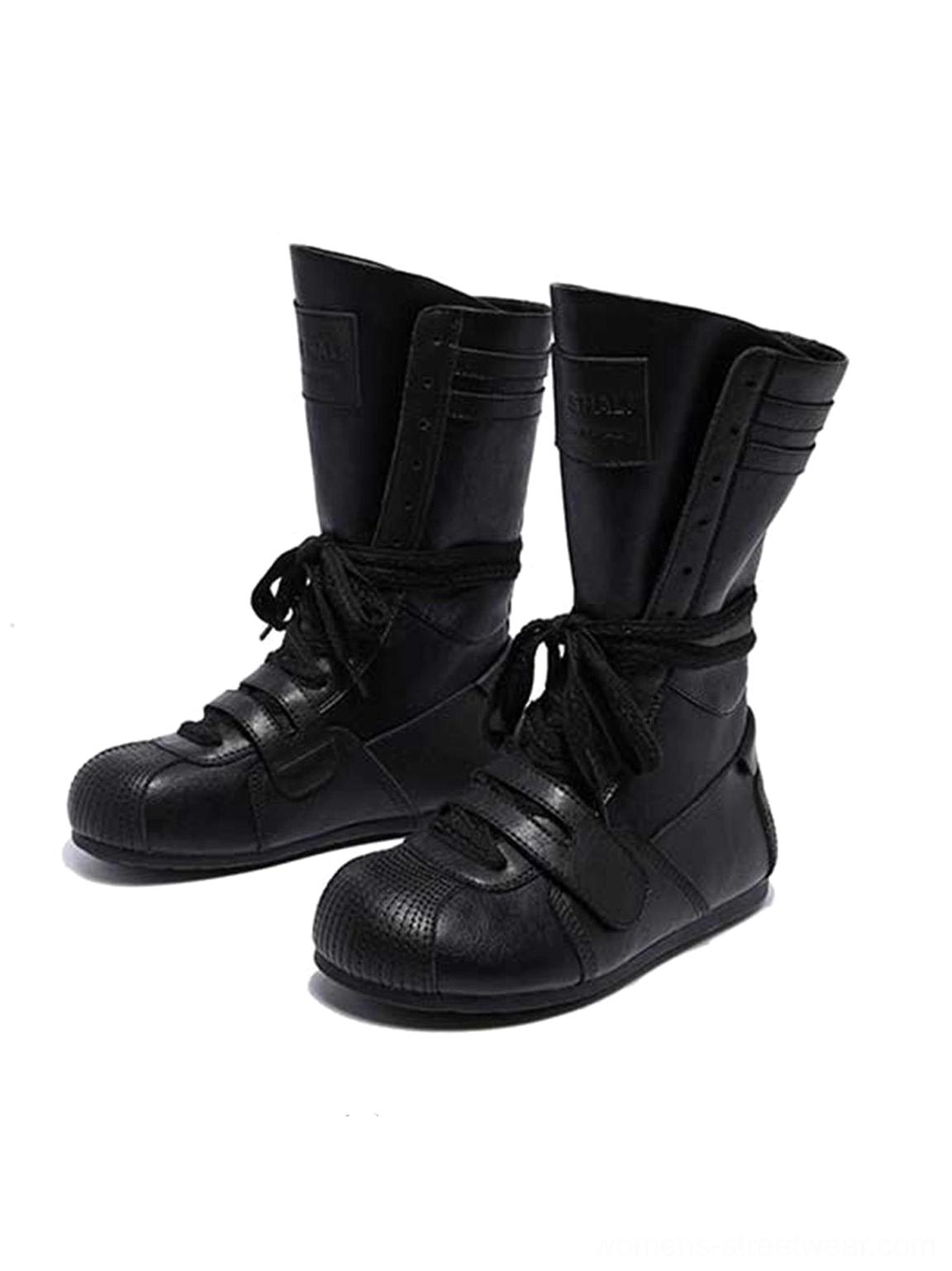 Pair of black boxing-inspired streetwear boots shown from the front with wraparound laces, front hook-and-loop straps, and structured mid-calf shafts