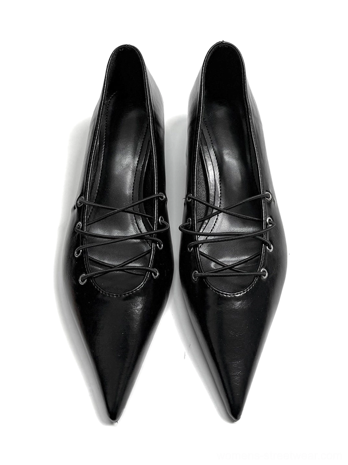 Pair of black pointed ballet flats with matching crisscross instep lacing, glossy leather-look finish, and metal eyelets