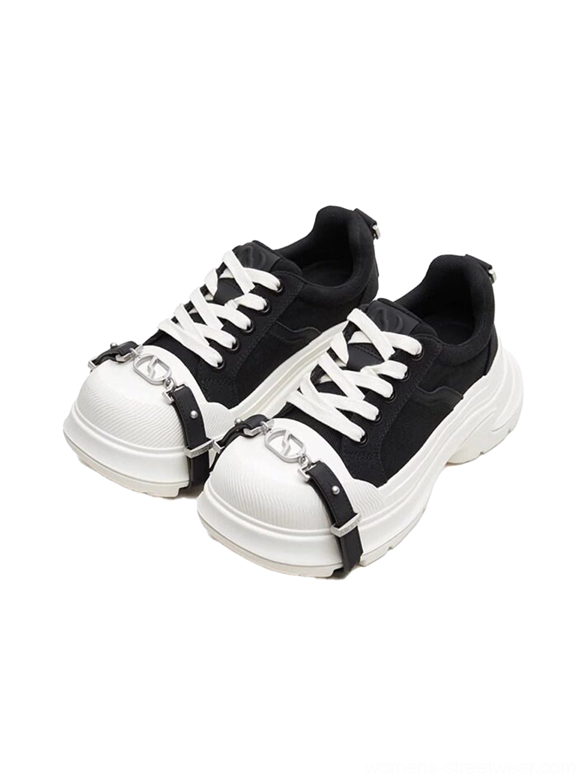 Pair of black and white buckle platform canvas sneakers displayed from the front with matching silver hardware and chunky white soles