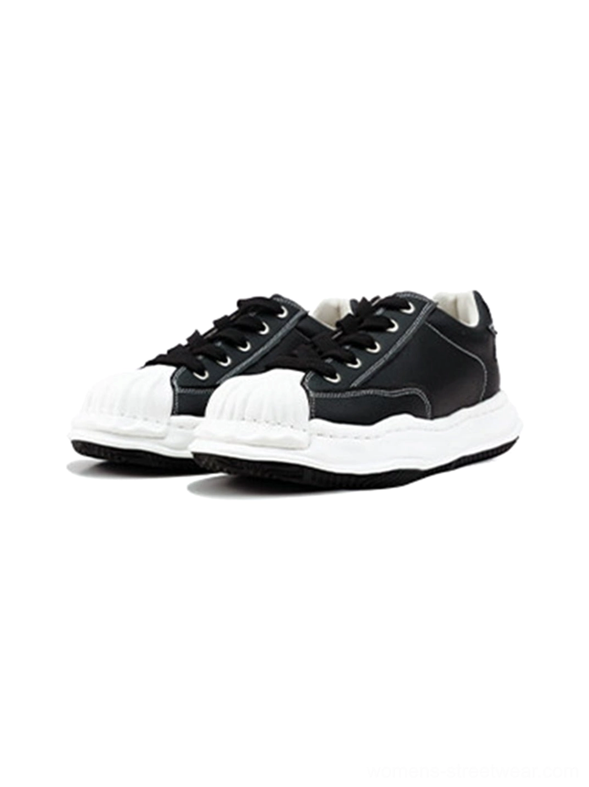 Pair of black and white molded shell-toe sneakers arranged symmetrically in an overhead studio product view