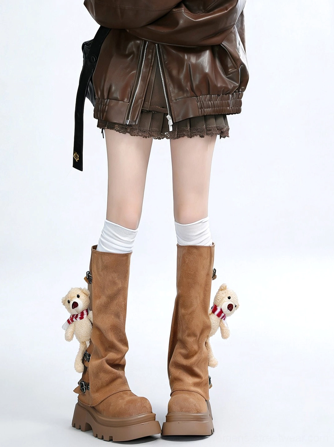 Pair of brown teddy bear decorated mid-calf boots with loose shafts and chunky lug platform soles