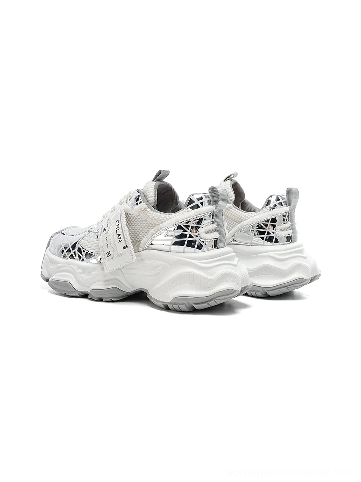 Pair of metallic silver mesh tech runner sneakers in a rear side view showing reflective grid uppers, subtle heel details, breathable panels, and chunky outsole construction