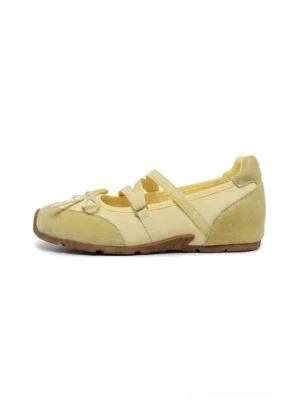 Pale yellow double-strap bow Mary Jane ballet flats with rounded toe and brown low-profile sole on white background