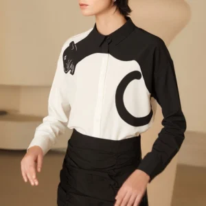 Three-quarter view of panther embroidered blouse tucked into a high-waisted black skirt with Korean streetwear styling