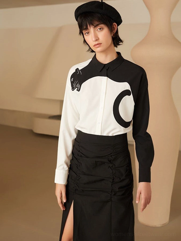 Panther embroidered blouse worn untucked with a high-waisted black skirt for a modern Seoul streetwear outfit