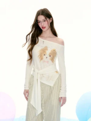Model wearing a cream Papillon dog print off-shoulder tie-waist streetwear top with long sleeves and asymmetrical hem
