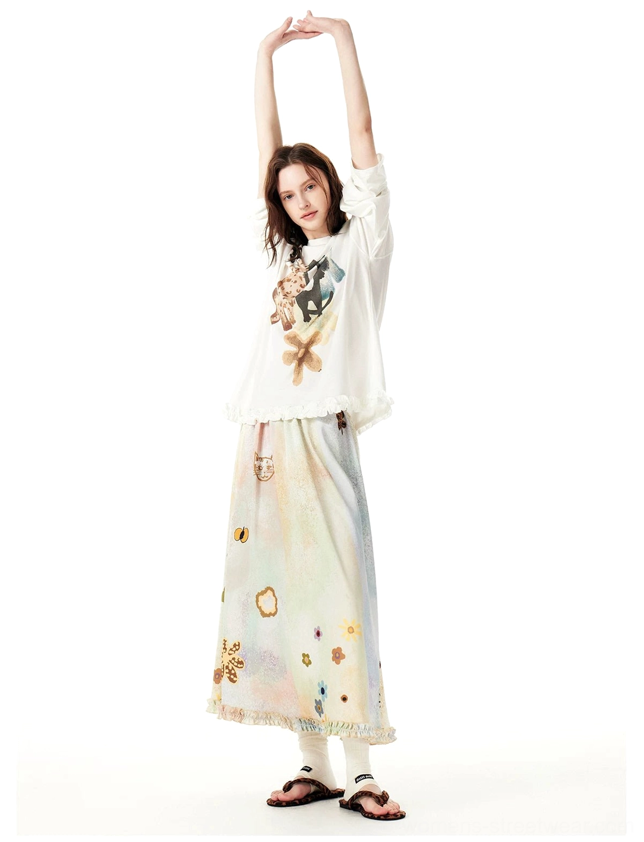 Front view of a pastel cat garden maxi skirt paired with a cropped graphic long sleeve tee in a Korean Y2K streetwear outfit