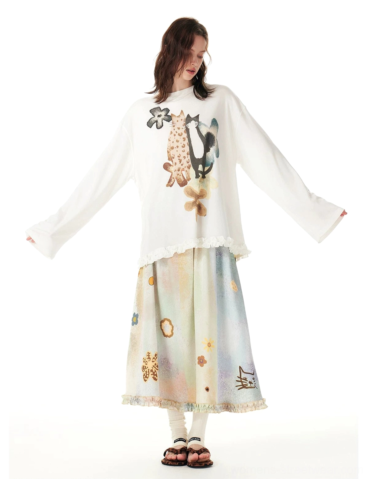 Front view of a pastel cat garden maxi skirt with watercolor floral motifs, ruffled hem, and oversized graphic tee streetwear styling