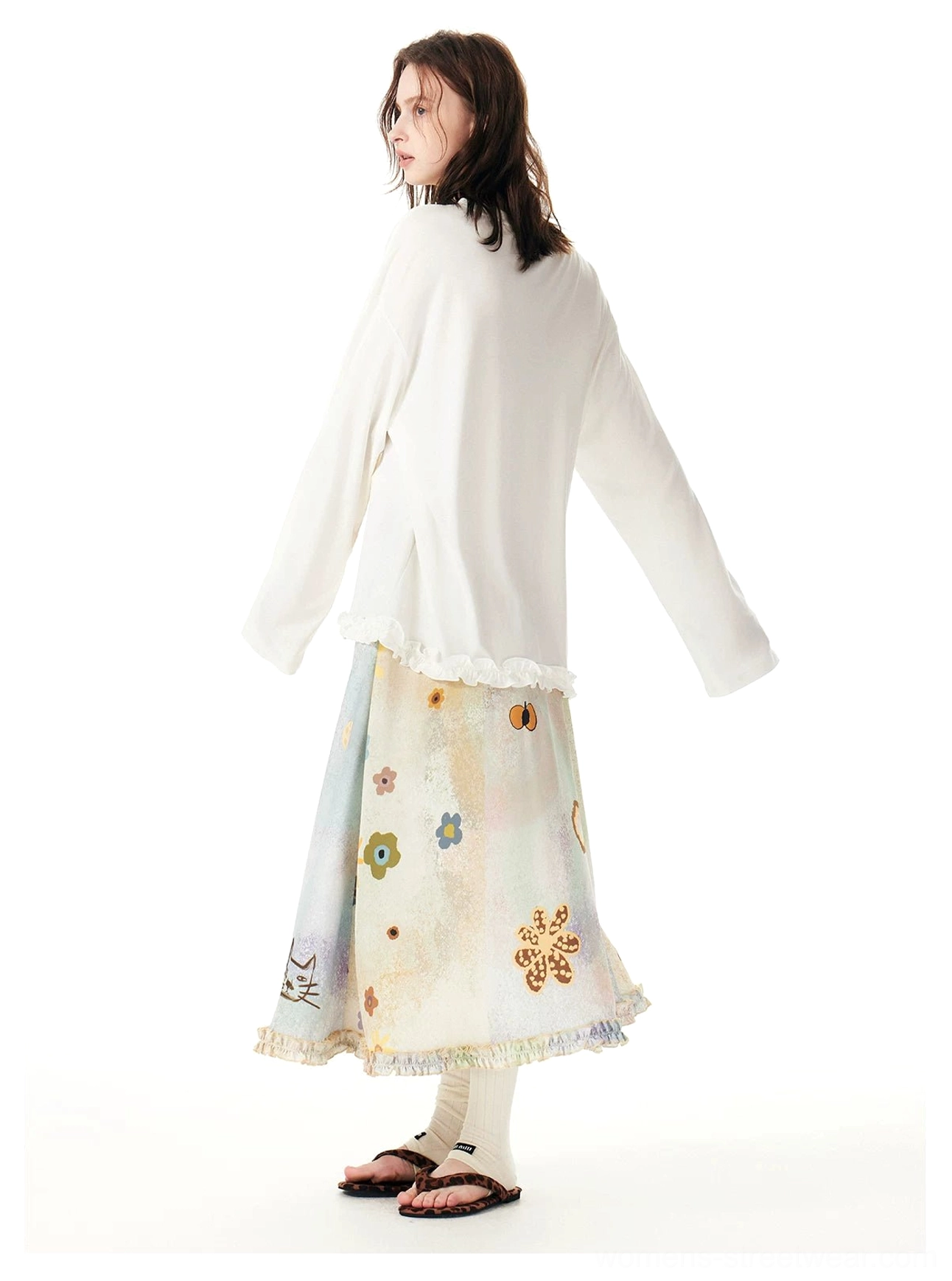 Rear view of a pastel cat print maxi skirt styled with an oversized white graphic long sleeve tee for relaxed Korean streetwear