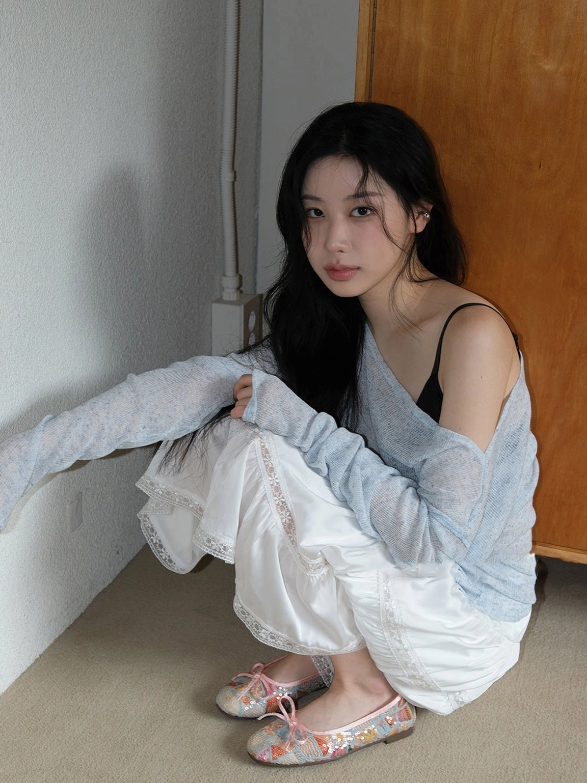 Floral mesh bow ballet flats styled with a light blue knit layer and white ruffle skirt in a casual romantic outfit