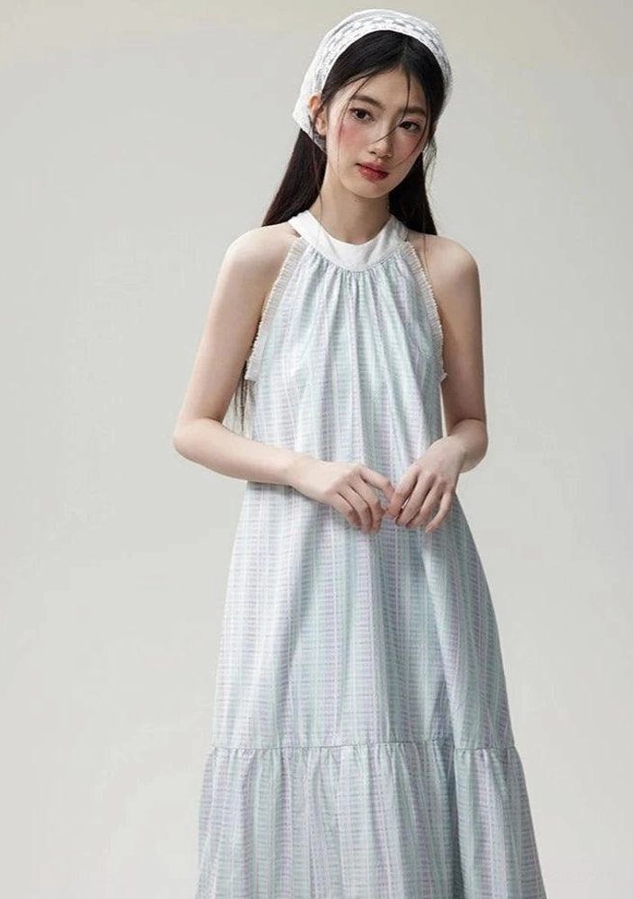 Half-body front view of a pastel gingham halter dress with lace-trimmed neckline, sleeveless design, and soft layered maxi skirt