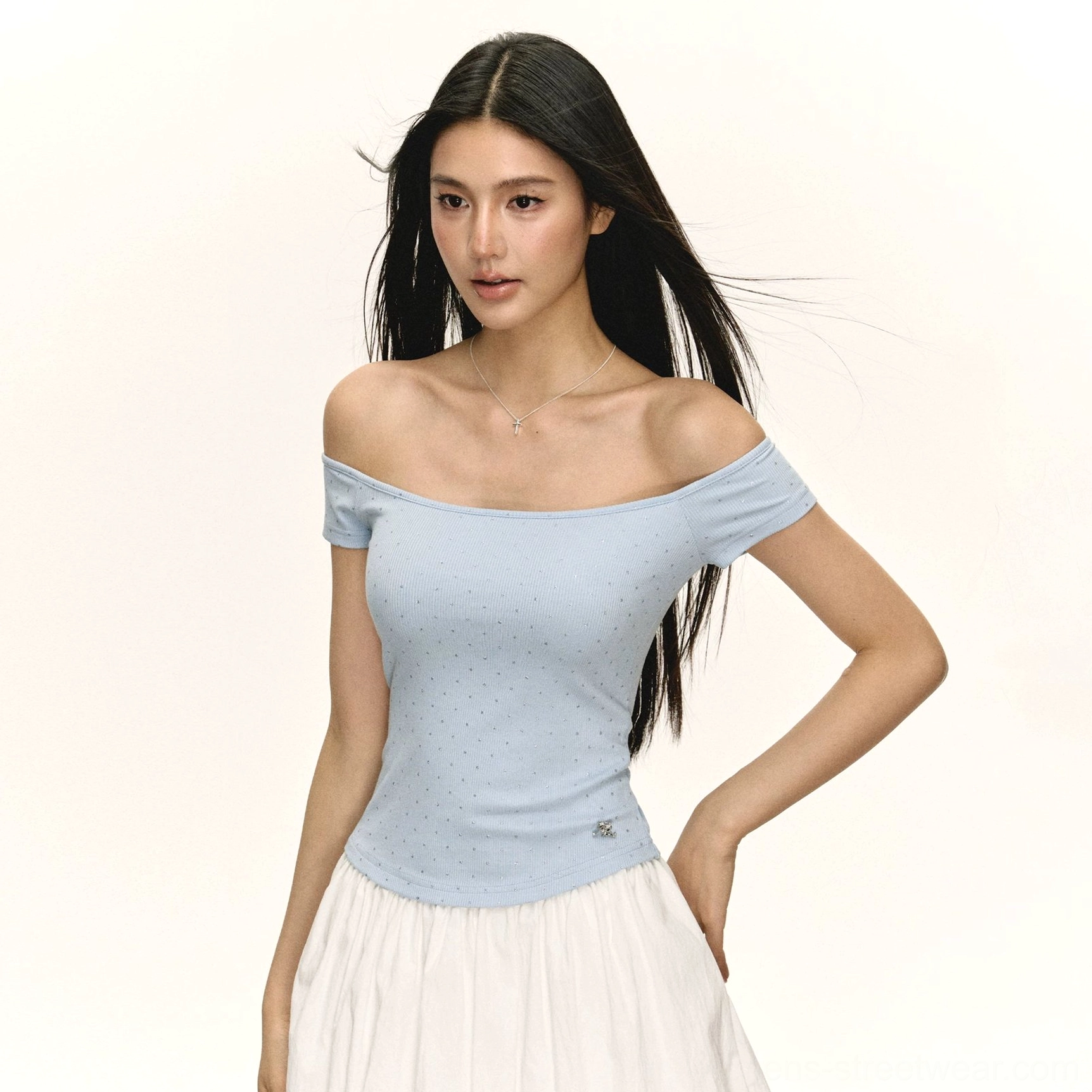 Pastel light blue solid off shoulder ribbed cropped top with a delicate hem charm styled with a white flowing midi skirt