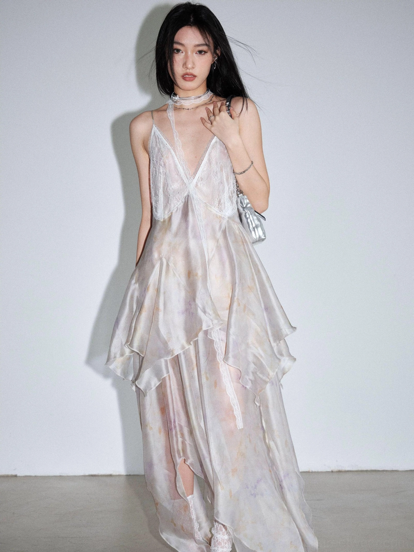 Pastel marbled tie dye chiffon slip dress in a full front view featuring deep V back, high side slit, layered skirt, and long flowing silhouette