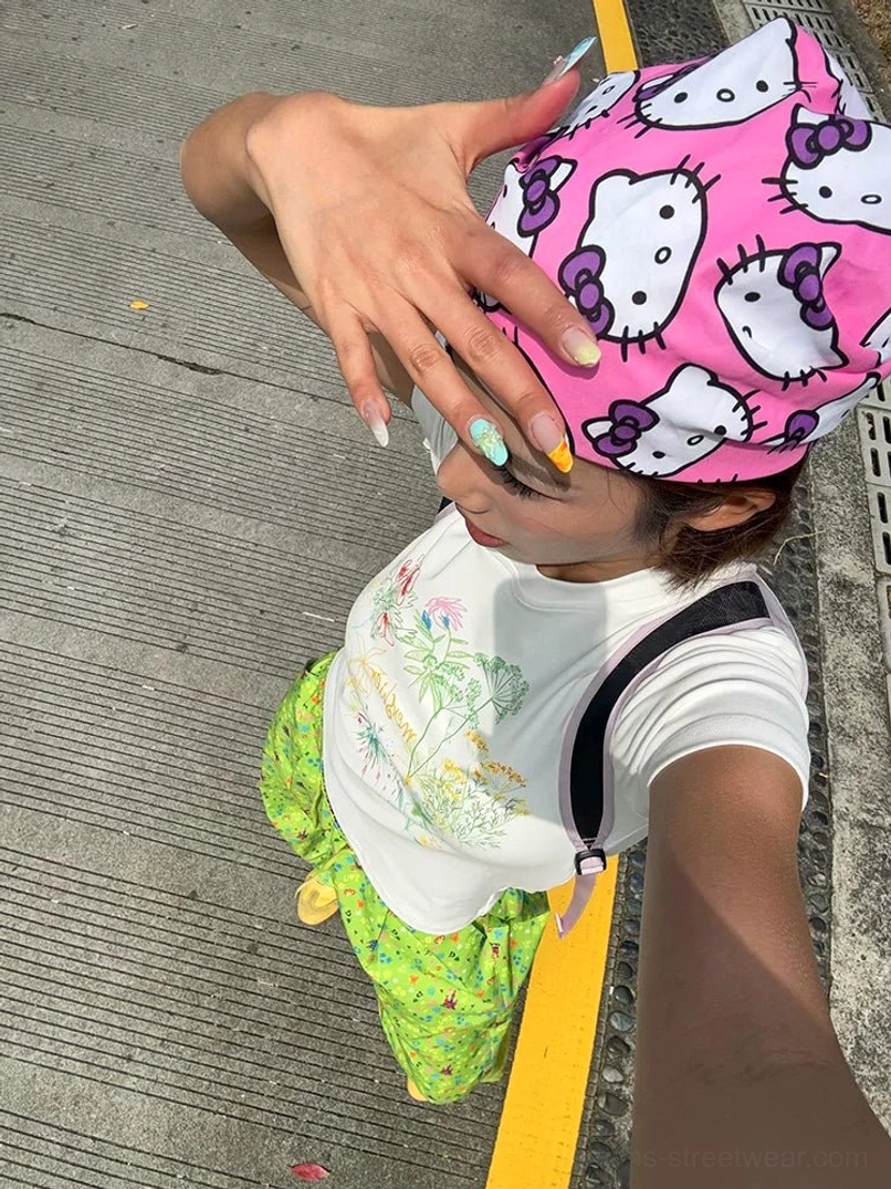 Overhead close-up of cream white pastel floral graphic tee with pink printed bandana styling