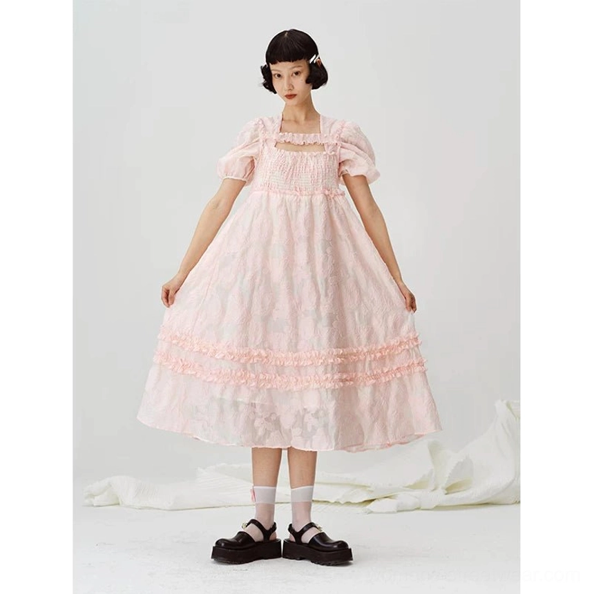 Front view of a pastel pink square-neck puff sleeve midi dress with a flowing A-line skirt and tiered ruffle hem